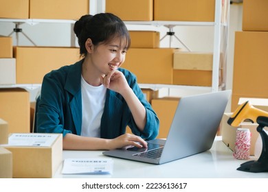 Young Female Small Business Entrepreneur, Online Business Startup Owner Woking On Laptop At Home Happy And Excited About Online Order Form Customers. Online Merketing, E-commerce Comept.