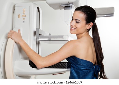 Young female smiling while taking a mammogram x-ray test - Shutterstock ID 124661059