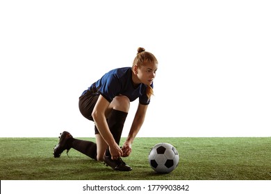 Young female soccer or football player with long hair posing confident, preparing for game isolated on white studio background. Concept of healthy lifestyle, professional sport, motion, movement. - Powered by Shutterstock