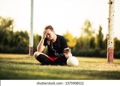 Young female soccer player resting after her training - Powered by Shutterstock