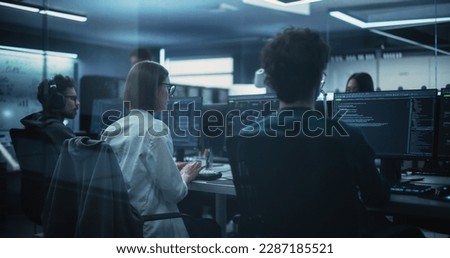 Young Female Software Developer Working on Computer Together with Two Friendly Male Colleagues. Female Asking Advice from a Male Colleague About a Solution for Their Collaborative Tech Project
