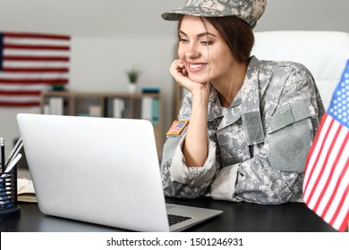 Young Female Soldier Working With Laptop In Headquarters Building