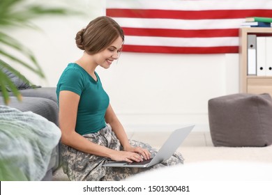 Young Female Soldier Working With Laptop In Headquarters Building