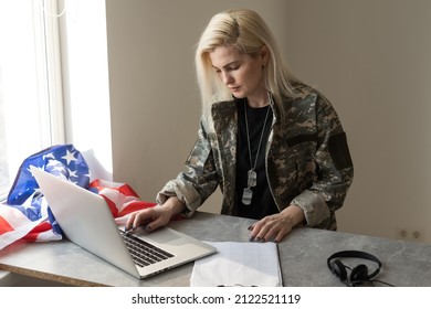 Young Female Soldier Working With Laptop In Headquarters Building.