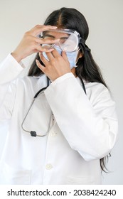 A Young Female South Asian Doctor From India Putting A Mask