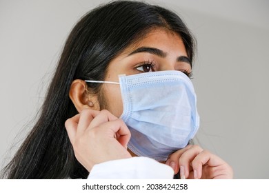 A Young Female South Asian Doctor From India Putting A Mask