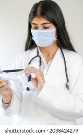 A Young Female South Asian Doctor From India Putting A Mask