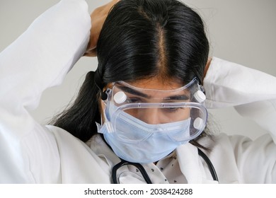 A Young Female South Asian Doctor From India Putting A Mask