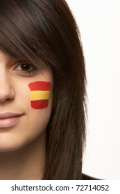 Young Female Sports Fan With Spanish Flag Painted On Face