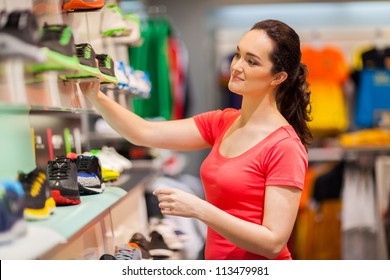 Young Female Sportswear Shop Assistant Working In Store