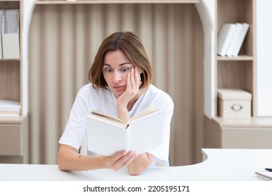 Young Female Student Shocked After Reading Interesting Chapter Of Book