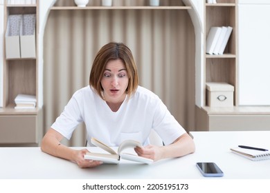 Young Female Student Shocked After Reading Interesting Chapter Of Book