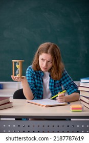 Young Female Student In Time Management Concept