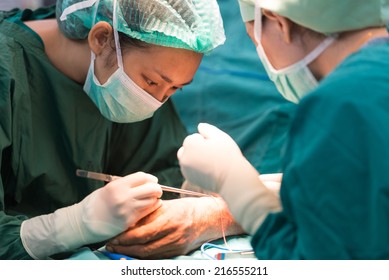 Young Female Surgeon Doing Operation