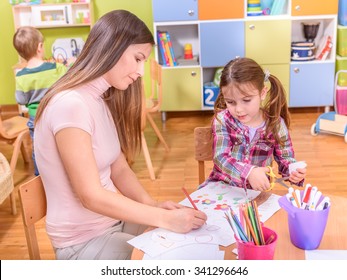 Young Female Teacher and Cute Girl in Kindergarten - Shutterstock ID 341296646