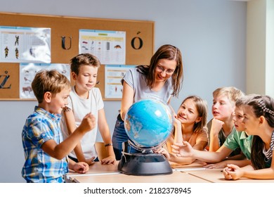 Young female teacher showing globe to children. Make the world a better place. Where will we go to travel next time? - Powered by Shutterstock