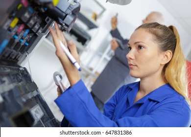 Young Female Technician Repairing Digital Printer