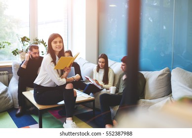 Young female teenage international student making report for her classmates offers creative ideas for making business plan for upcoming testing in university working together on informal meeting  - Powered by Shutterstock