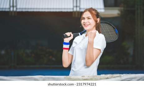 Young female tennis player celebrating after winning training game on court. Human emotions, winner, sport, victory concept. - Powered by Shutterstock