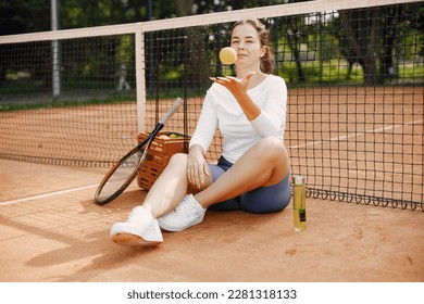 Young female tennis player relax after match - Powered by Shutterstock