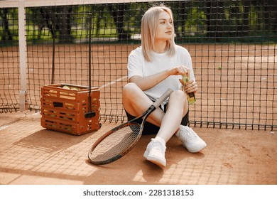 Young female tennis player relax after match - Powered by Shutterstock