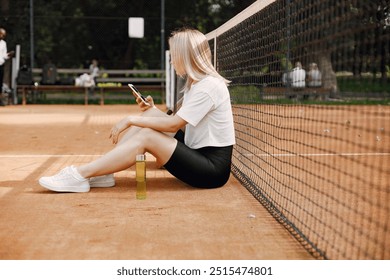 Young female tennis player relax after match - Powered by Shutterstock