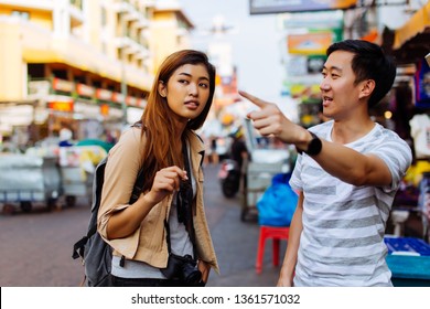 Young Female Tourist Asking For Directions And Help From Local People In Bangkok, Thailand