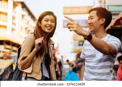 Young Female Tourist Asking For Directions And Help From Local People In Bangkok, Thailand