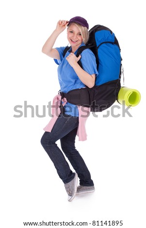 young female tourist in baseball cap with backpack