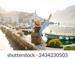Young female tourist enjoys the view of the city. Europe travel. Lifestyle, vacation, tourism, nature, active life.