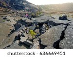 Young female tourist exploring surface of the Kilauea Iki volcano crater with crumbling lava rock in Volcanoes National Park in Big Island of Hawaii, USA 