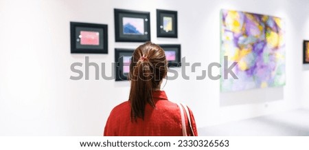 Young female tourist looking gallery exhibition. Art, Painting, photography, Inspiration and museum concept
