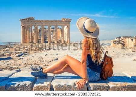 Young female tourist looking at Parthenon Athens greece temple