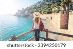 Young female tourist looking at Red tower in Alanya, Antalya in Turkey