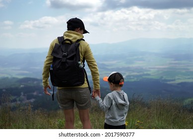Young female tourist standing with her son and enjoying beautiful view in the mountains, Slovakia, High Tatras                      