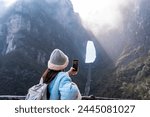 Young female tourist taking a photo of the The Heaven