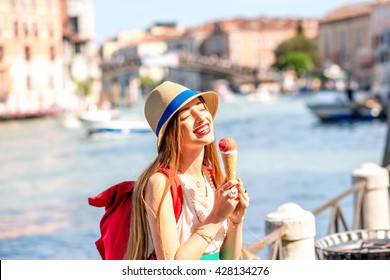 Young Female Traveler Eating Traditional Italian Ice Cream Called Gelato In The Waffle Cone In Venice.