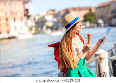 Young Female Traveler Eating Traditional Italian Ice Cream Called Gelato In The Waffle Cone In Venice.