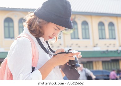 Young female Traveller or Asian Traveller looking her camera while touring the city space in Bangkok, Thailand - Shutterstock ID 785615662