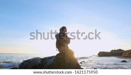 Image, Stock Photo Young woman with pipe backlit by the sea in the midnight sun