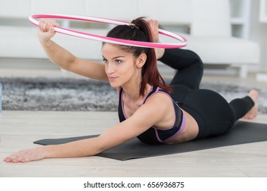 Young Female Using A Hula Hop At Home