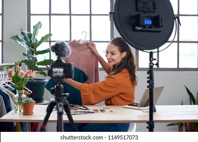 Young female vlogger recording content for her online fashion channel on social media, giving fashion advice - Powered by Shutterstock