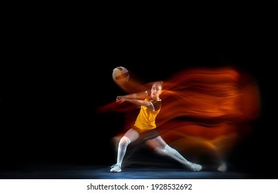 Young female volleyball player isolated on black studio background in mixed light. Woman in sportswear training and practicing in action. Concept of sport, healthy lifestyle, motion and movement. - Powered by Shutterstock