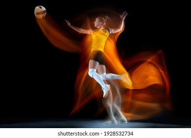 Young female volleyball player isolated on black studio background in mixed light. Woman in sportswear training and practicing in action. Concept of sport, healthy lifestyle, motion and movement. - Powered by Shutterstock