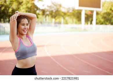 Young Female Warm Up Outdoor Morning Before Workout And Jogging At The Football Stadium With Sunbeam.