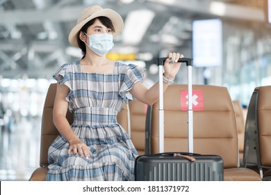 Young female wearing surgical face mask in airport terminal, protection Coronavirus disease (Covid-19) infection, Asian woman traveler sitting on chair. New Normal, social distancing and safety travel - Shutterstock ID 1811371972