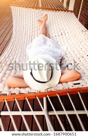 Similar – Young woman relaxing in a hammok