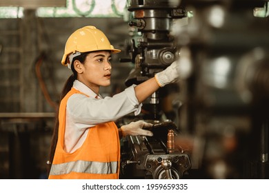 Young female women attend worker happy working in metal factory workplace work engineer fix maintenance heavy industry machine.