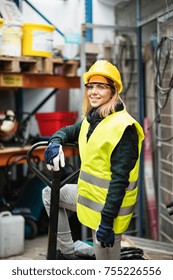 Young Female Worker In A Warehouse.