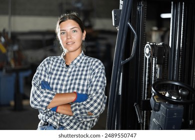 Young female worker working on forklift at a metallurgical plant - Powered by Shutterstock